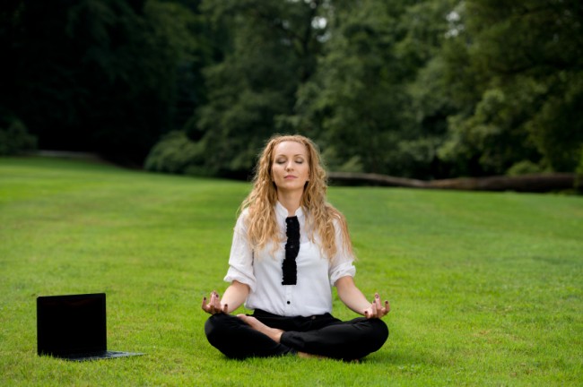 Professional Woman Meditates in a Field