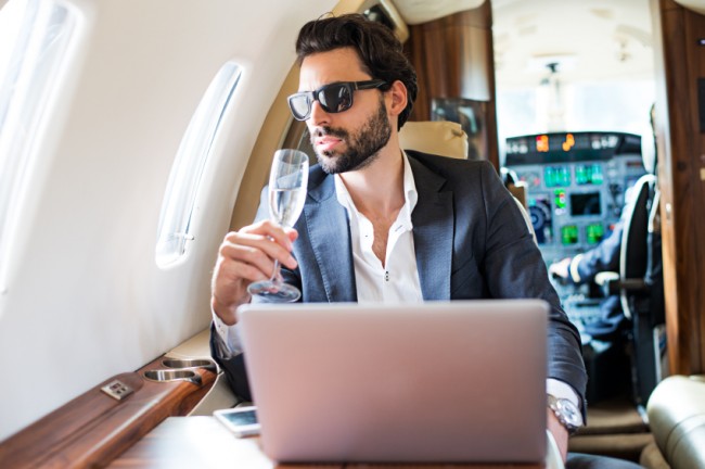 Man Sips Champagne on Airplane