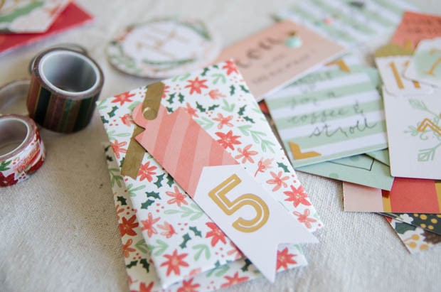 An activity-based advent calendar DIY from CreativeLive! https://blog.creativelive.com/diy-a-lovely-advent-calendar-with-my-minds-eye-christmas-on-market-street-supplies/