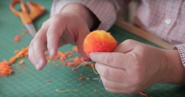 Learn how to make a yarn pom pom with step-by-step instructions and a video tutorial from crafter, Robert Mahar.