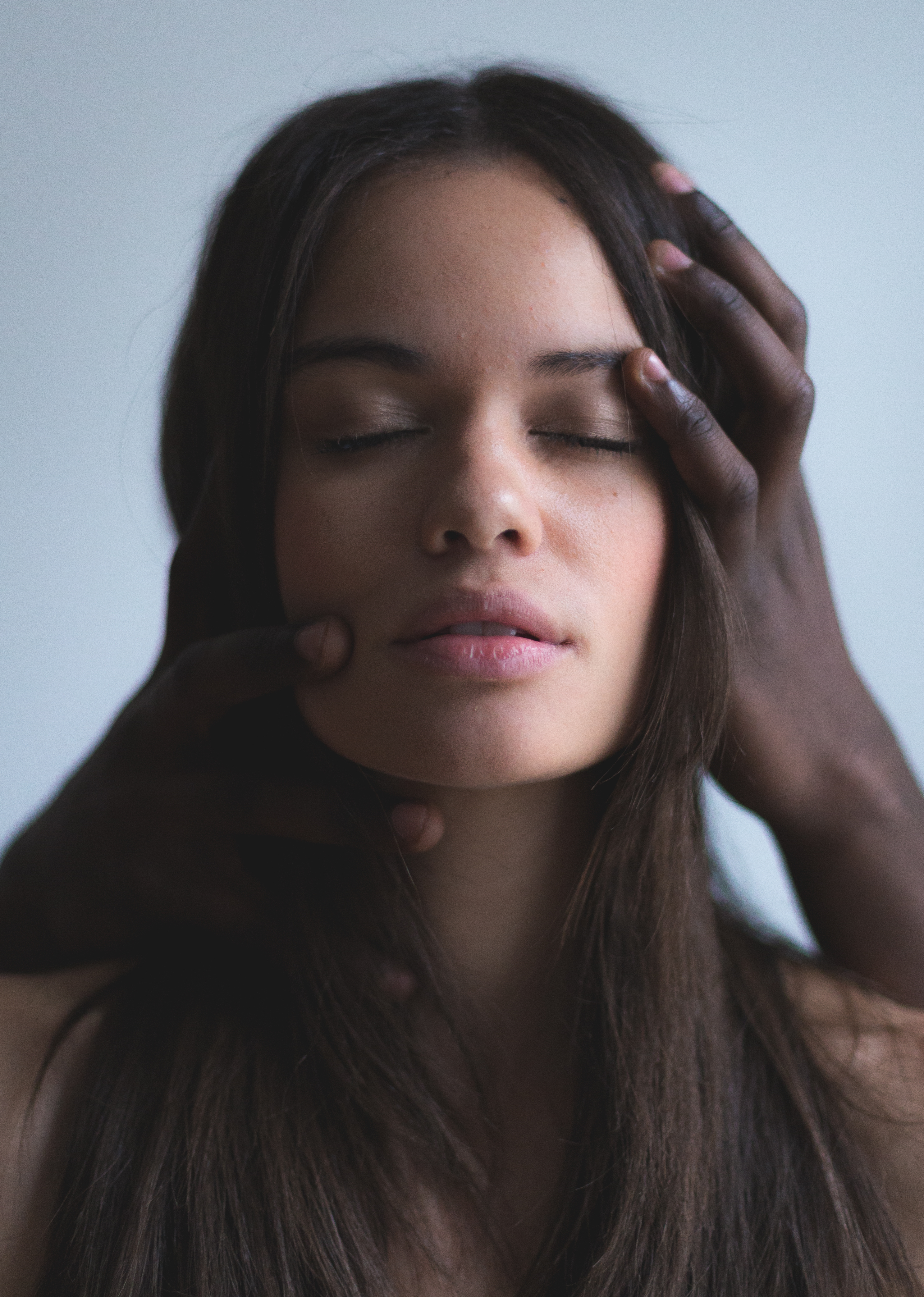 Moody Portrait of woman with Man's Hands