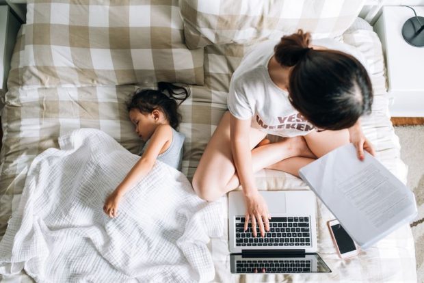 Work-from-home jobs are on the rise. Woman works at home with her daughter.