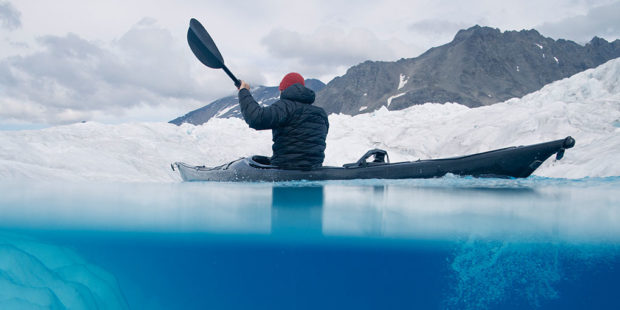 Alex Strohl, founder of Wildist paddling in a canoe 
