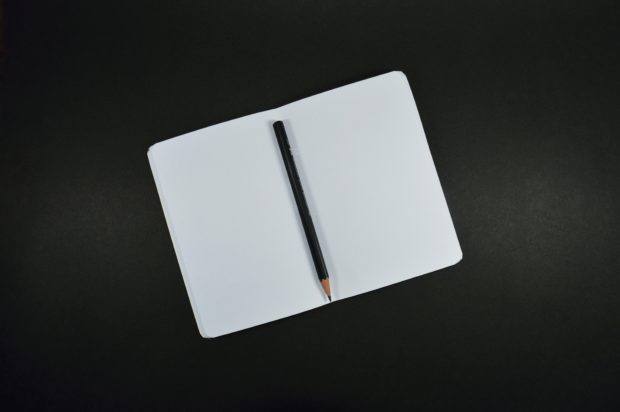 top down shot of empty notebook with pencil to record creative inspiration