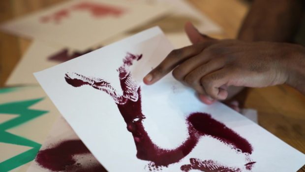 Raven Guenneguez points to textures he's created in his art that help him deal with stress