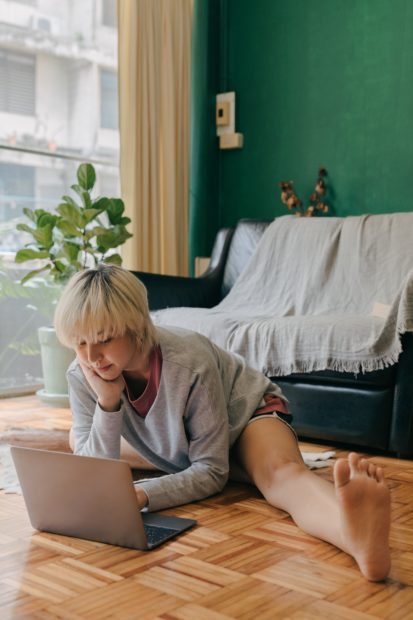 Woman stretching on floor while working 