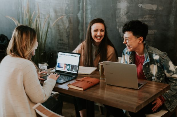 coworkers working on business together and laughing 